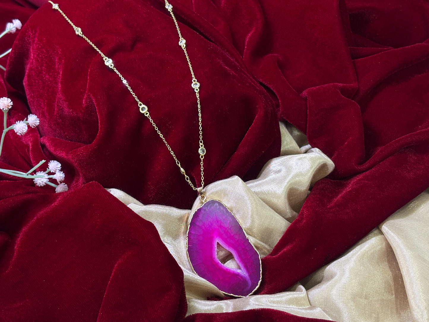 Purple charm in gold toned chain