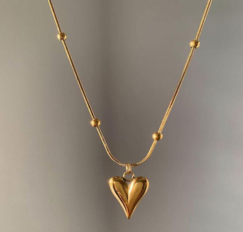 Heart-shaped charm, expertly crafted in a radiant gold finish.